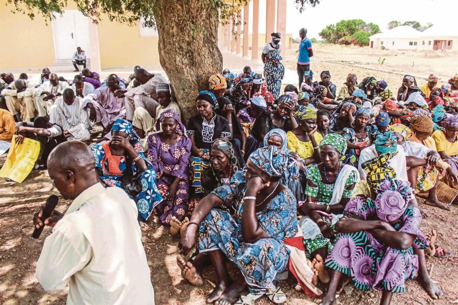 Parents and relatives attending a commemoration in Chibok, Nigeria, on April 14, 2019, five years after 276 girls were abducted by the Boko Haram group. A decade since the mass abduction, almost 100 girls are still thought to be in captivity. AFP PIC