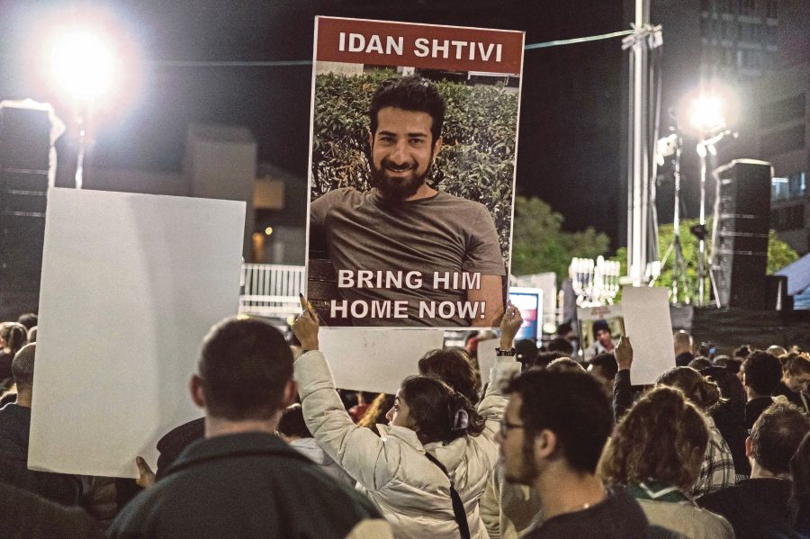 A demonstrator holding a poster of Israeli hostage Idan Shviti, who is held in Gaza, outside the Tel Aviv Museum of Art, now informally called the Hostages Square, on Saturday. AFP PIC 