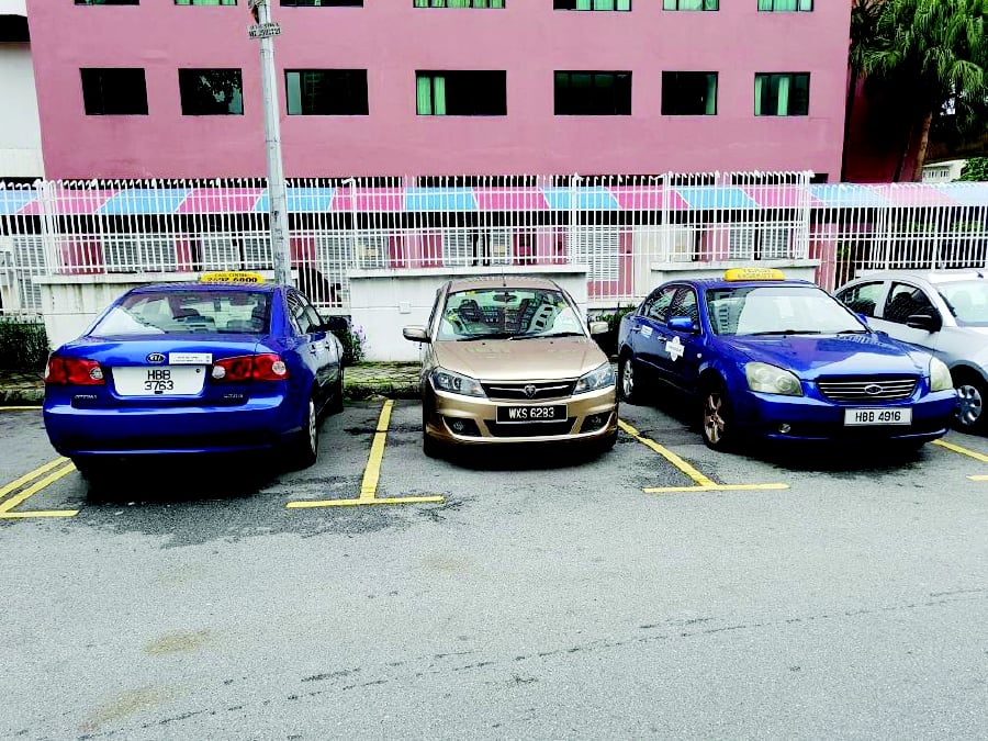 The abandoned vehicles at a car park in Chow Kit, Kuala Lumpur. Residents say the vehicles have been left in the parking area for more than two years. 