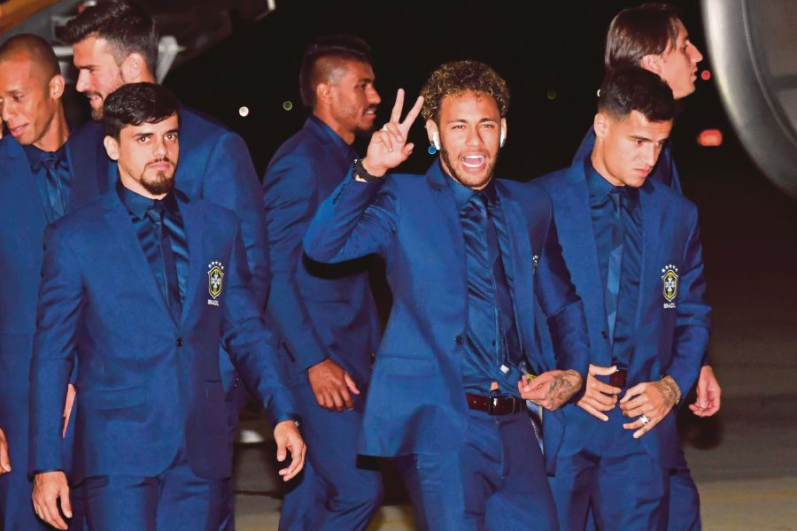 (File pix) (From left) Brazil's Fagner, Neymar and Philippe Coutinho and the rest of the national team arriving at Sochi International Airport, Russia, yesterday ahead of the World Cup. AFP Photo