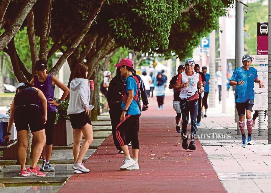 People exercising at a public park in Putrajaya last year. Leading a healthy lifestyle shouldn’t stop at the park. - NSTP file pic