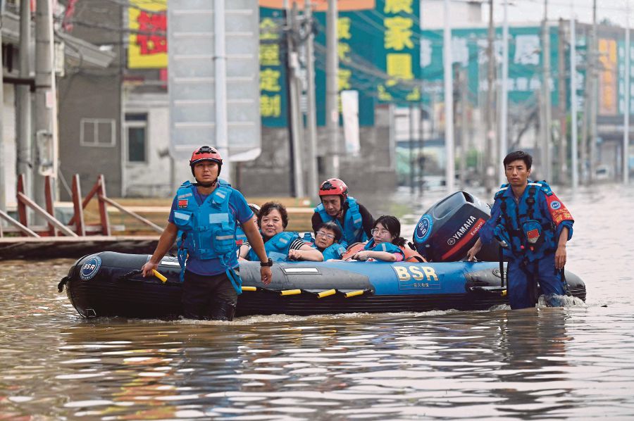 Rescuers evacuating residents following heavy rains in Zhuozhou city, Hebei province, China, recently. There was no major spike in searches for climate change in recent weeks on either the Weibo microblog platform or China’s biggest search engine, Baidu. AFP PIC