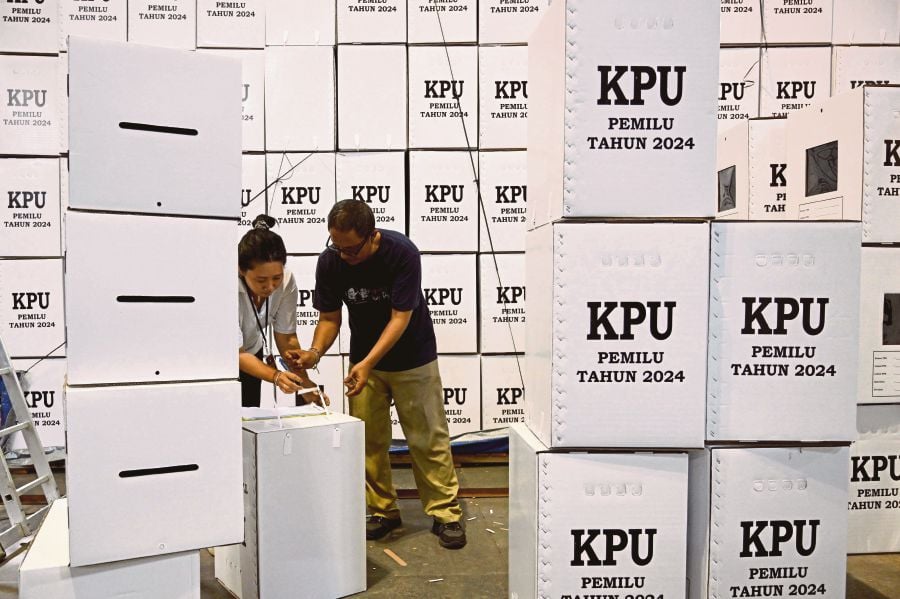 Workers preparing ballot boxes at the logistics warehouse of the Denpasar General Election Commission in Denpasar, Bali, last month. AFP PIC 