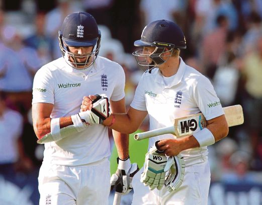 England’s James Anderson (left) shakes hands with Joe Root at end of play on Saturday. AP pic