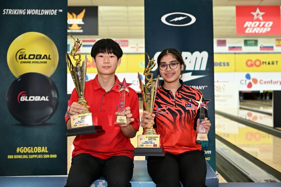 South Korea’s Bae Jung Hyun and Adelia Nur Irwan Syazalee pose with their trophies after being crowned the boys and girls Open winners of the International Junior All-Stars on Friday