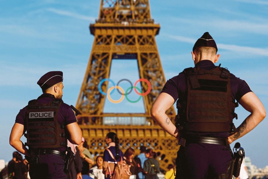 Police officers patrolling Trocadero square in front of the Olympic rings on the Eiffel Tower in Paris, France, on June 7. REUTERS PIC