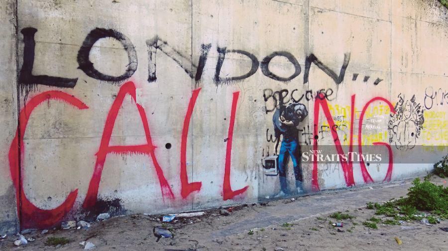 A graffiti by street artist Banksy of Apple founder and son of Syrian immigrants, Steve Jobs, vandalised with the words ‘London Calling’ to reflect the desire of most refugees to come to England. PIX BY ZAHARAH OTHMAN