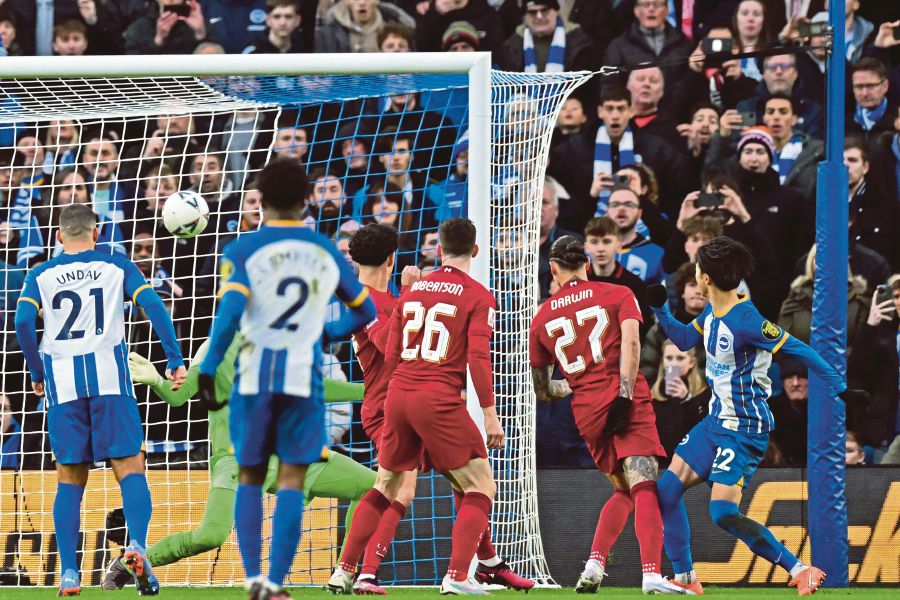 Brighton's Japanese midfielder Kaoru Mitoma (R) scores their second goal during the English FA Cup fourth round football match between Brighton & Hove Albion and Liverpool at the Amex stadium in Brighton, on the south coast of England. AFP FILE PIC