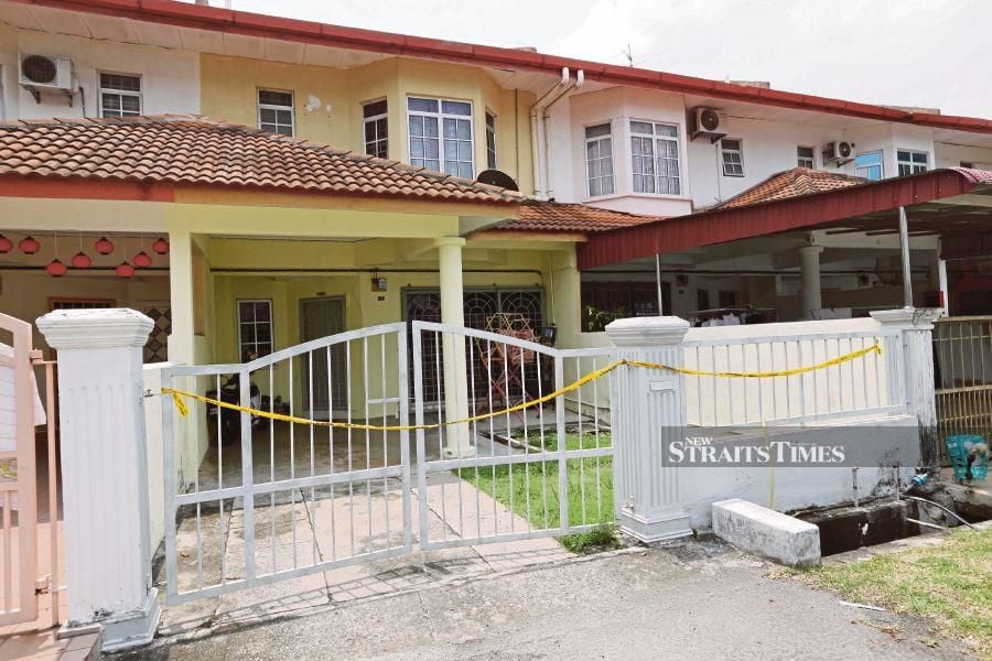 The heads ofa woman and her stepson were retrieved from this rented house in Taman Merdeka Jaya, Melaka, where she stayed with her husband. PIC BY KHAIRUNISAH LOKMAN