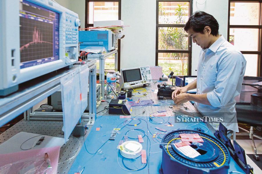  A researcher at Universiti Malaya studying fibre optics in 2018. FILE PIC