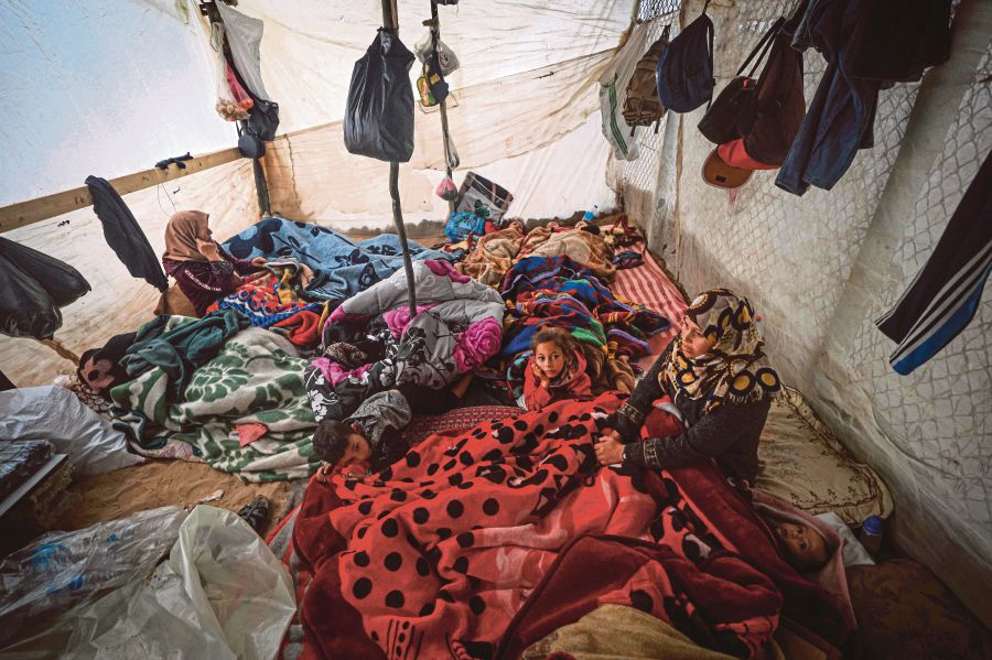 Palestinians resting in their tent at a camp for displaced people in Rafah, southern Gaza Strip, on Wednesday. AFP PIC