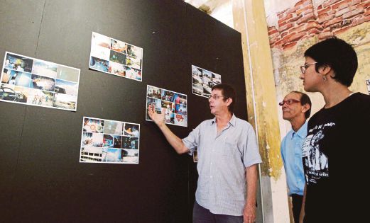 James Lochhead (left) of Suaram Penang showing some of the works at the former Hin Bus station, Jalan Gurdwara, Penang. Pix by Ramdzan Masiam