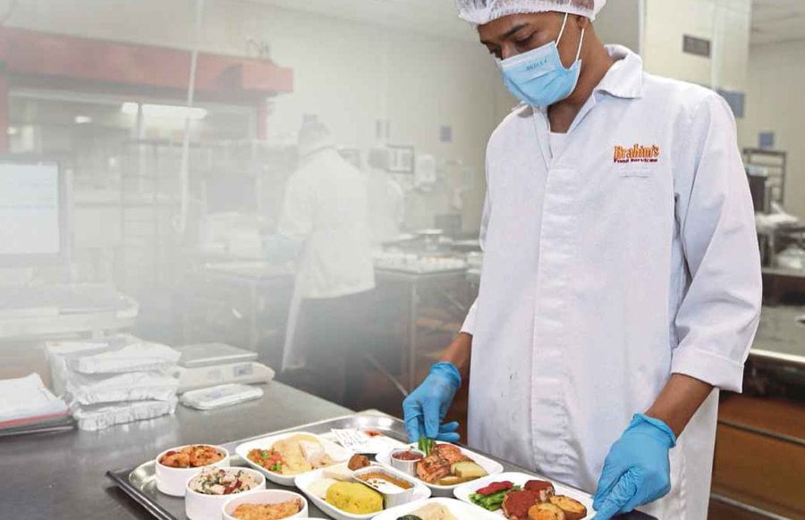 A Brahim’s employee preparing flight meals at the catering company’s central kitchen.
