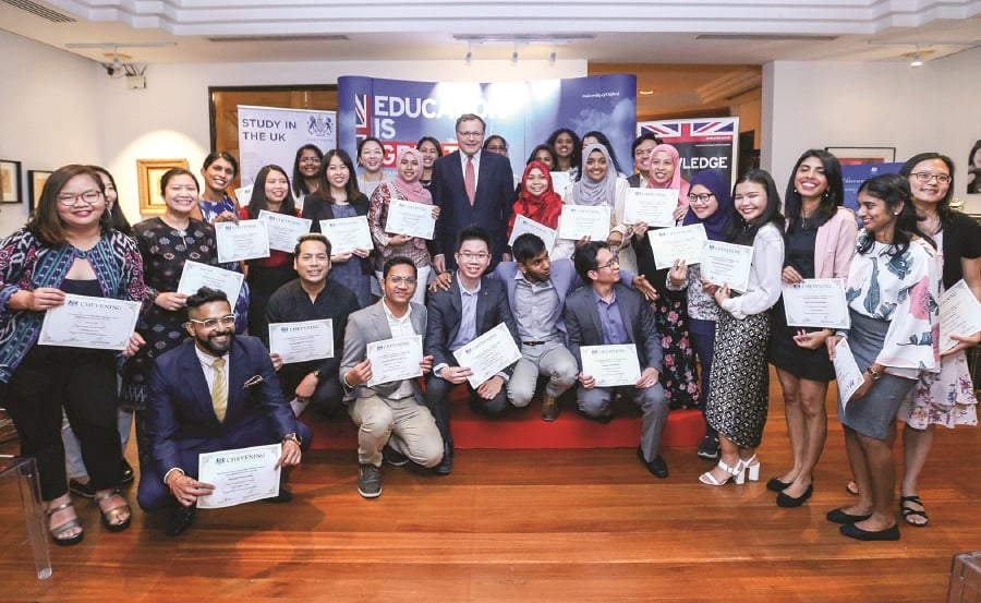 British High Commissioner to Malaysia, Charles Hay (centre), with the returning Chevening scholars from the 2018/2019 academic year at a welcome home reception at the British High