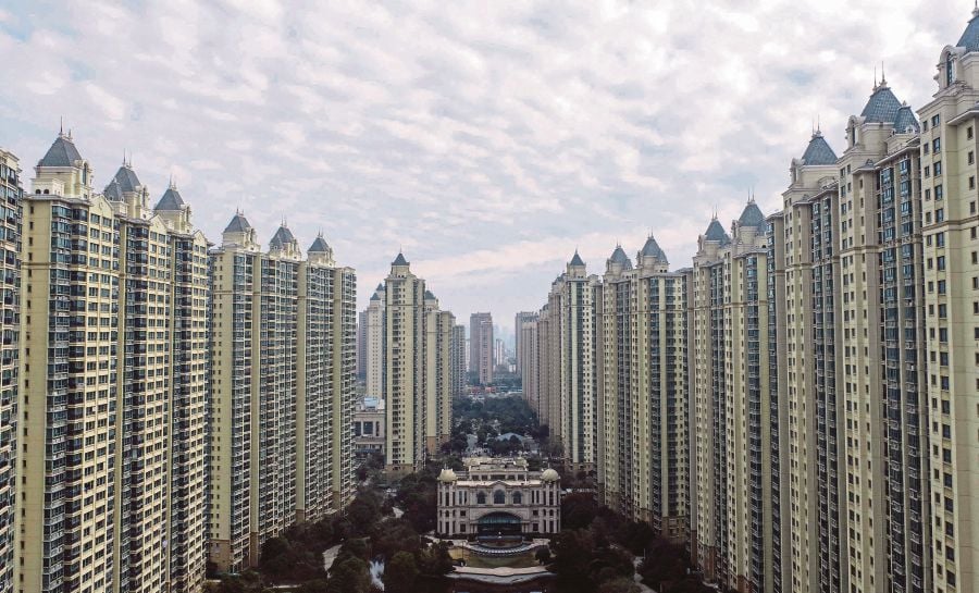 This aerial photo taken shows a housing complex by Chinese property  (Photo by AFP) / China OUT