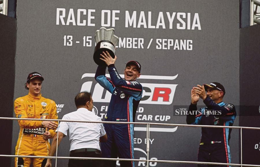 BRC Hyundai N Squadra Corse’s Norbert Michelisz hoists the trophy after winning the World Touring Car Cup’s Race One at the Sepang Circuit yesterday. PIC BY ZULFADHLI ZULKIFLI