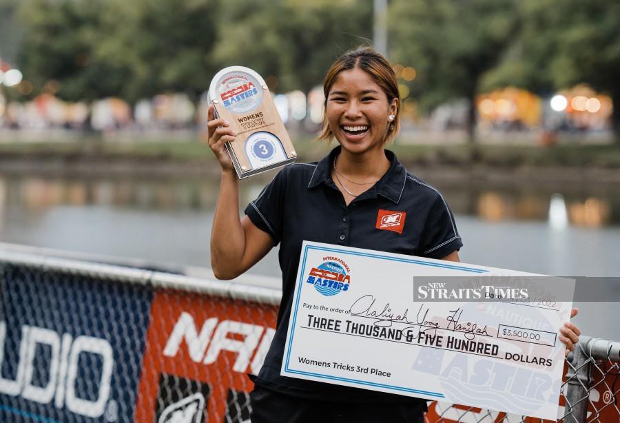 Aaliyah Yoong Hanifah with the trophy and cheque after winning gold at the Moomba Masters in Melbourne yesterday.