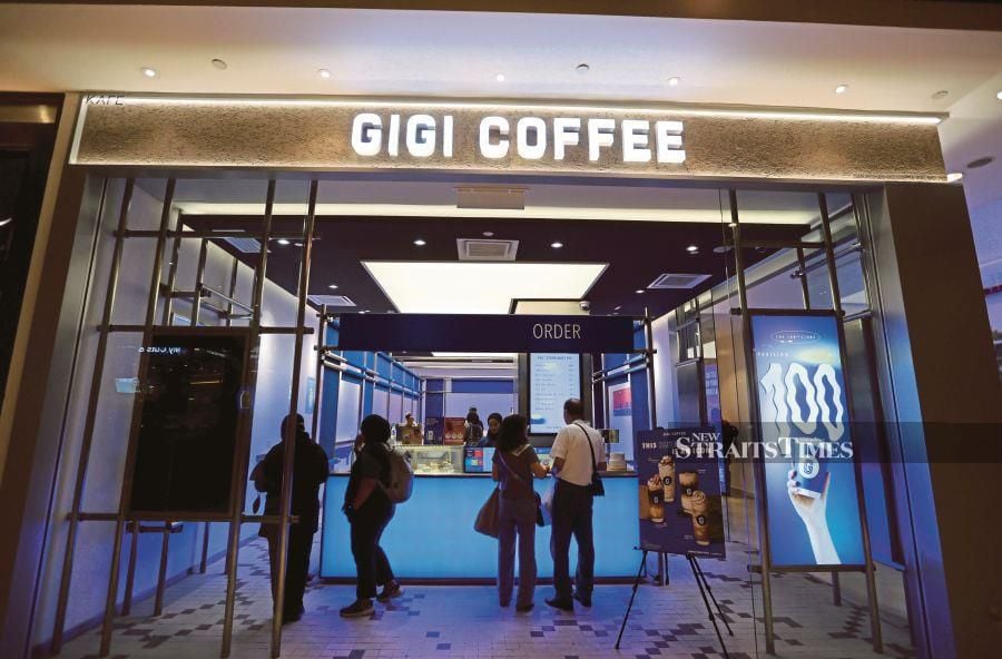 Customers at a branch store of Gigi Coffee, a local brand, at Pavilion Kuala Lumpur, yesterday. Local coffee franchisees saw a revenue spike of up to 30 per cent as a result of the boycott on brands with Israel links. - NSTP/ASWADI ALIAS