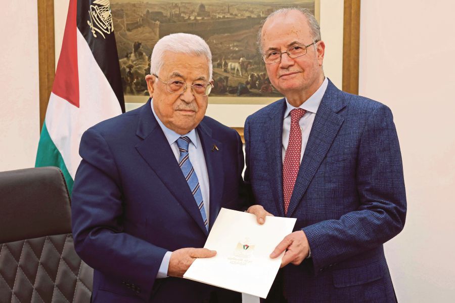 This handout picture provided by the Palestinian Authority's Press Office (PPO) shows Palestinian President Mahmoud Abbas (left) with the newly appointed Palestinian Prime Minister Mohammad Mustafa in Ramallah on Thursday. AFP/PALESTINIAN PRESS OFFICE PIC