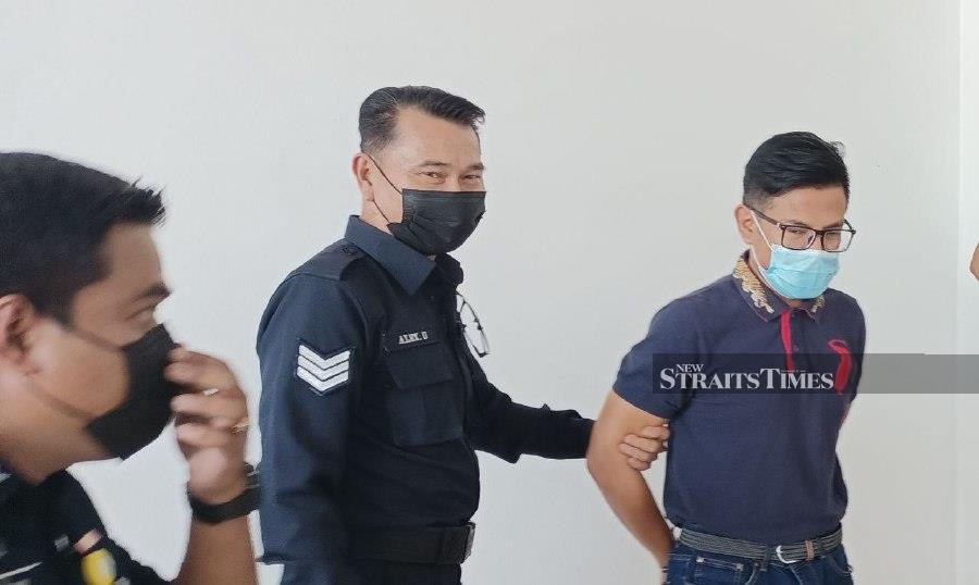 Mohammad Shah Soep (right) escorted by police after the court's proceeding. Mohammad Shah was sentenced to a total of 15 years imprisonment plus nine strokes of whipping for seven counts of cheating over so-called multimillion ringgit projects. -NSTP/ERSIE ANJUMIN