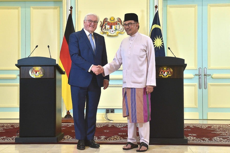 Prime Minister Datuk Seri Anwar Ibrahim (R) shakes hands with Germany's President Frank-Walter Steinmeier (L) after a joint press conference in Putrajaya on February 17, 2023. -AFP PIC