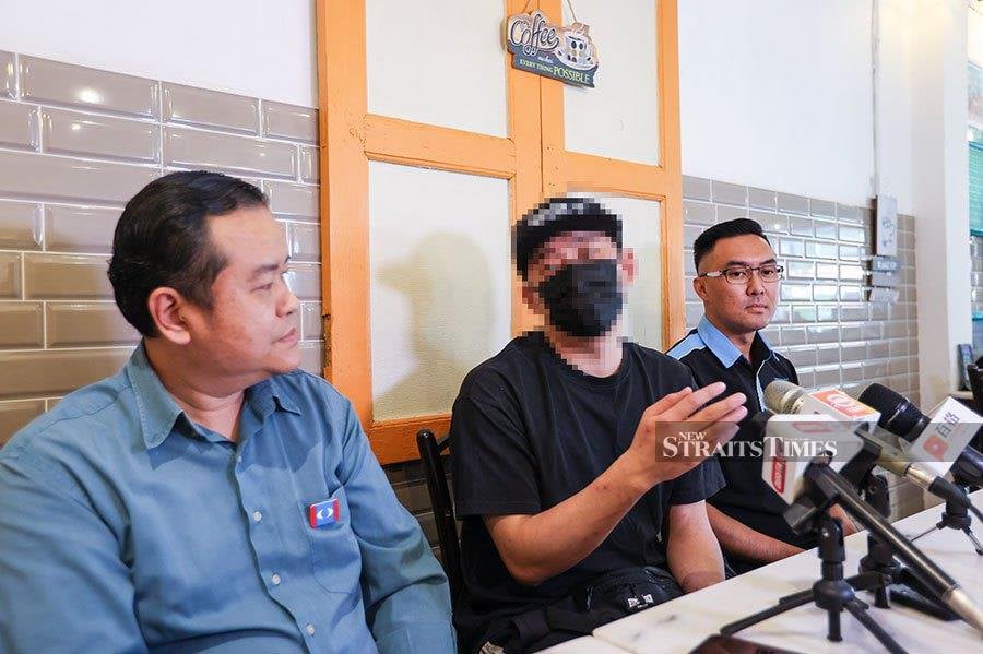 One of the victims who only wanted to be identified as Ah-Huat (center), 29, said he was duped by an overseas job offer promising a lucrative salary. NSTP/ASWADI ALIAS
