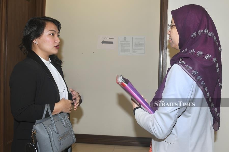Lawyer representing Siti Nafirah Siman, Shireen Sikayun (left) with Psychologist, Dr Noor Aishah Rosli outside the courtroom before the trial involving a lawsuit against an English teacher at SMK Taun Gusi, in Kota Belud, who was allegedly absent from class for seven months in 2015 at the Kota Kinabalu High Court. -NSTP/MOHD ADAM ARININ