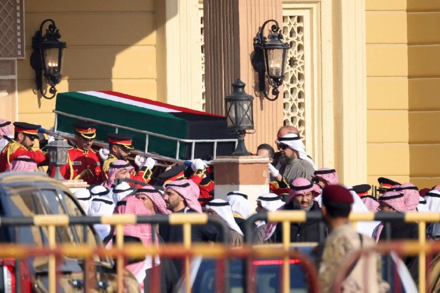 The coffin of Kuwait's late Emir Sheikh Nawaf al-Ahmad Al-Sabah is carried out of the Bilal bin Rabah Mosque in Kuwait City ahead of burial during his funeral on Dec 17, 2023. AFP PIC