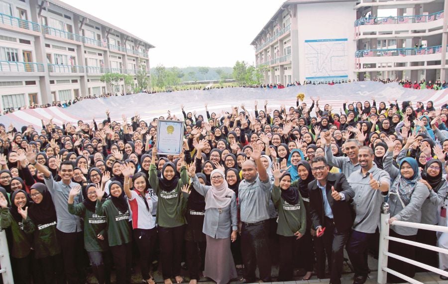 TKC principal Anismah M. Noh (front, middle) said love for the country must start at school and this can be done by indulging the students in numerous activities involving the whole school which will strengthen unity and the camaraderie. (pix by ADZLAN SIDEK)