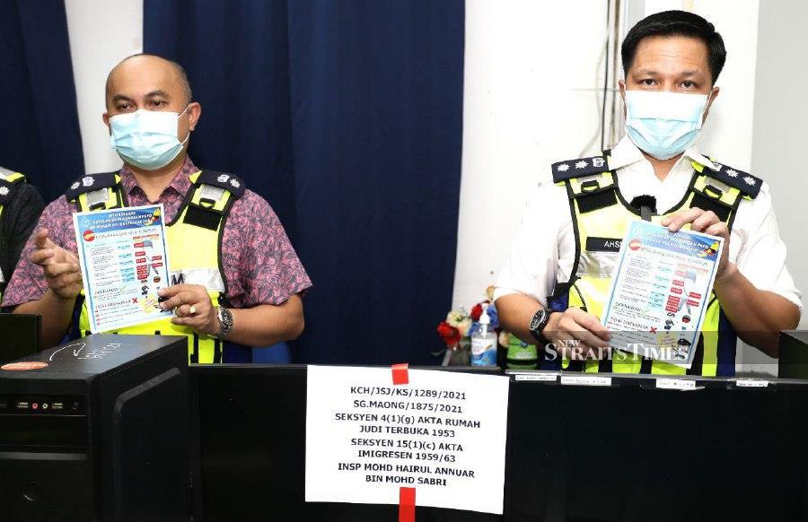 Kuching police chief ACP Ashmon Bajah (right) said the police raided two apartment units at Jalan Lapangan Terbang, around 11.50am, simultaneously. 