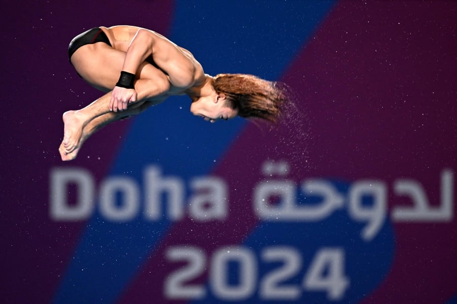 Malaysia's Bertrand Rhodict Anak Lises competes in the final of the mixed team diving event during the 2024 World Aquatics Championships at Hamad Aquatics Centre in Doha on February 2, 2024.- AFP pic
