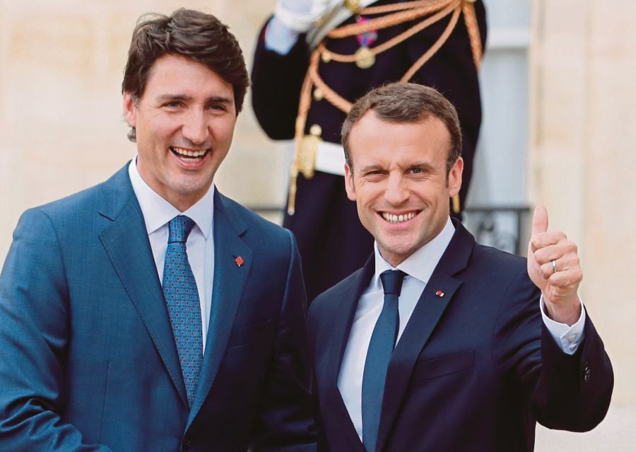 Macron, Trudeau deepen 'bromance' in Paris | New Straits ...