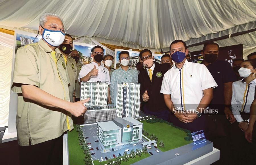 Prime Minister Datuk Seri Ismail Sabri Yaakob (left) with a model of the new FAM headquarters at yesterday’s ground-breaking ceremony in Putrajaya. - NSTP/MOHD FADLI HAMZAH