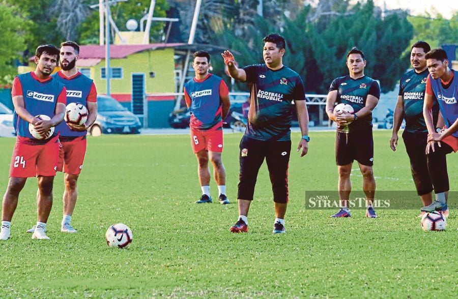 Kedah coach Aidil Sharin Sahak (centre) will have to prepare the team for two away matches in six days.