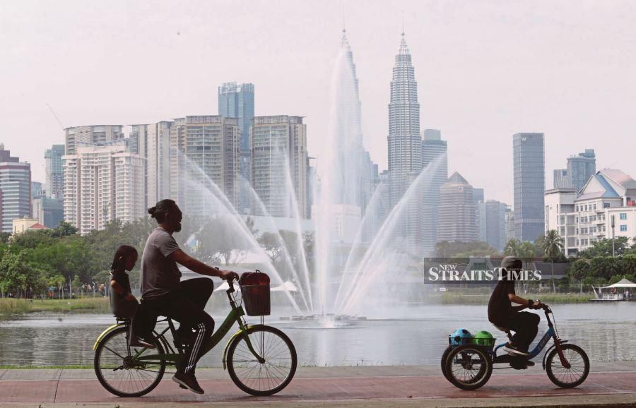 A family bicycling in Taman Tasik Titiwangsa, Kuala Lumpur, yesterday. Global developments have hampered Malaysia’s efforts to rebuild the economy. - NSTP/Mohamad Shahril Badri Saali