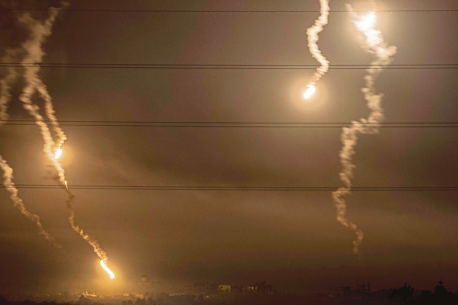This picture taken from a position along the border with the Gaza Strip in southern Israel shows flares launched by Israeli forces above the Palestinian territory. Video games developed with artificial intelligence can generate footage that will look similar to this scene and fool many viewers. AFP PIC 