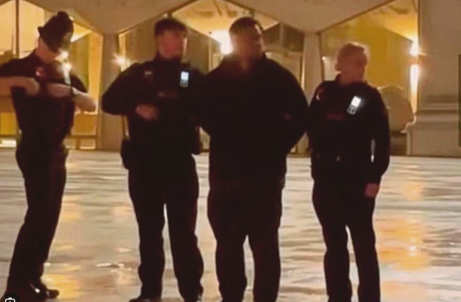 The alleged stalker (second from right) being arrested by the UK police shortly before his release on bail. The man had followed Acacia Diana to London in 2021. 