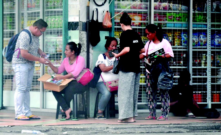 Some women are seen selling contraband cigarettes in the open. PIC BY MOHD NAZLLIE ZAINUL