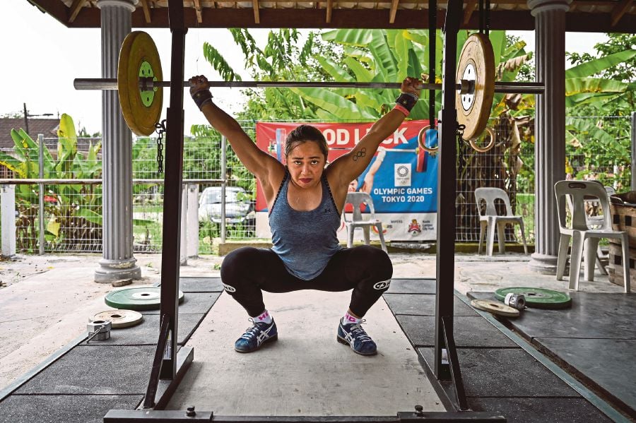 This picture taken on May 21, 2021 shows Olympic weightlifter Hidilyn Diaz of the Philippines lifting weights during a training session in Jasin, Melaka. - AFP PIC
