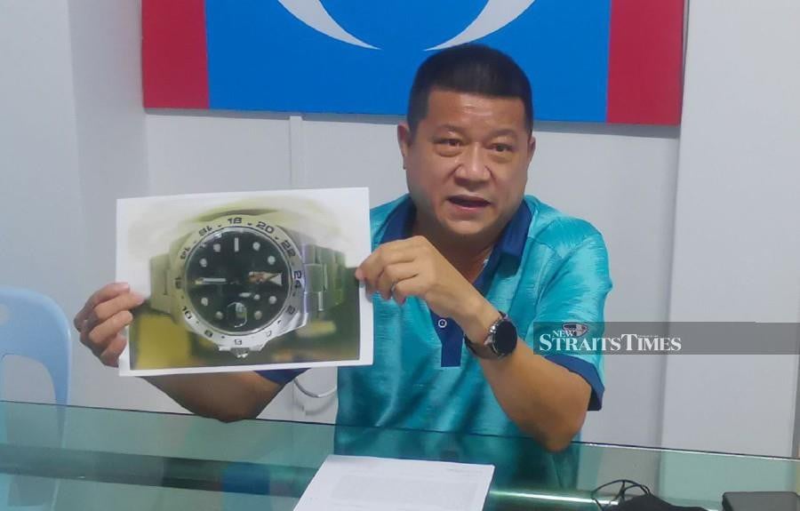 Teruntum assemblyman Sim Chon Siang showing an image of Andy's limited-edition 'Rolex Explorer II' luxury watch. -NSTP/T.N. ALAGESH