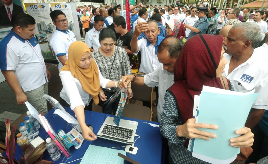 Locals collecting form for the People’s Housing Projects in Labuan during the launch of Labuan Development Blueprint 2030 at Dataran Labuan. Pic by EDMUND SAMUNTING