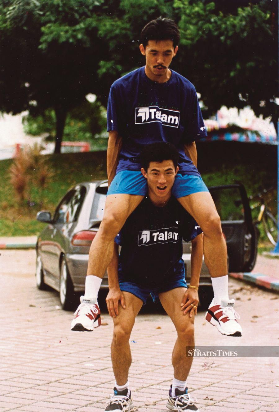 Former national player Ong Ewe Hock playfully gives Rashid Sidek a lift on his shoulders after a training session on April 26, 1996. - NSTP file pic