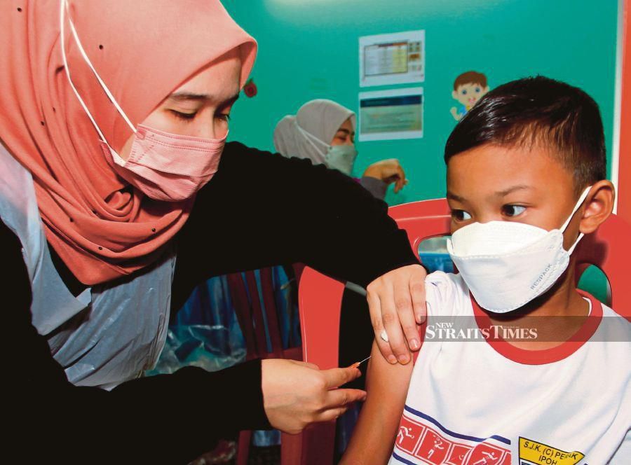 An 8-year-old boy receiving a dose of the Covid-19 vaccine at the Taman Meru Multipurpose Hall Vaccination Centre in Ipoh yesterday.- BERNAMA PIC 