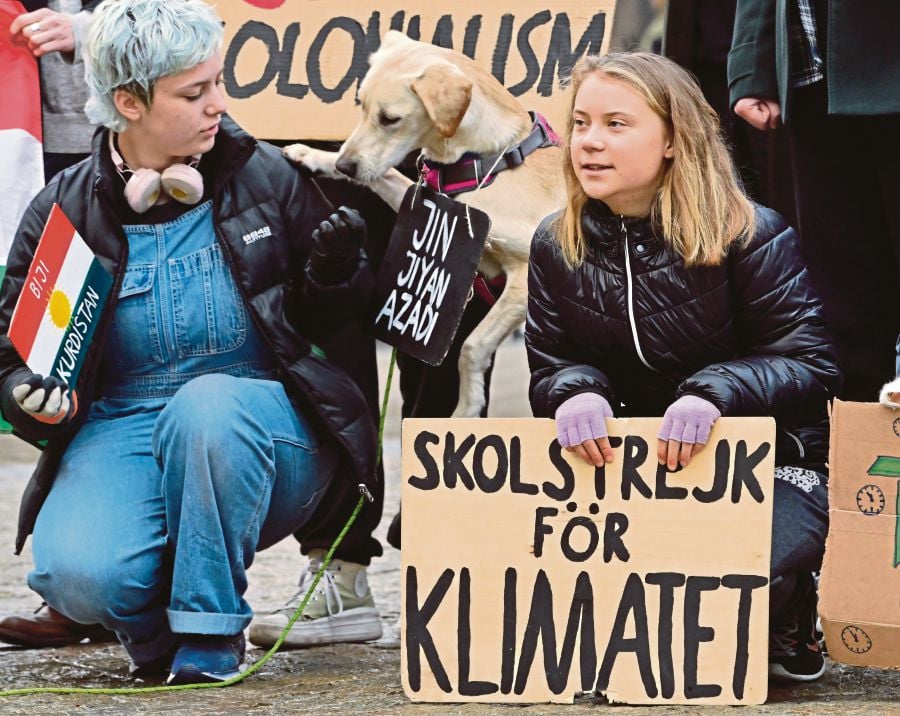  Climate and youth activist Greta Thunberg at a Fridays for Future protest in Stockholm last Friday. Her sign reads ‘School strike for the climate’. EPA PIC 