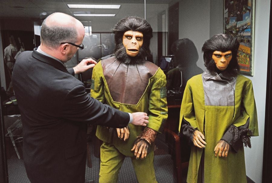 A man adjusting chimpanzee costumes worn in 1968’s ‘Planet of the Apes’, which were displayed during a Heritage Auction Galleries auction preview in Beverly Hills, the United States,  on March 16, 2010. -AFP PIC