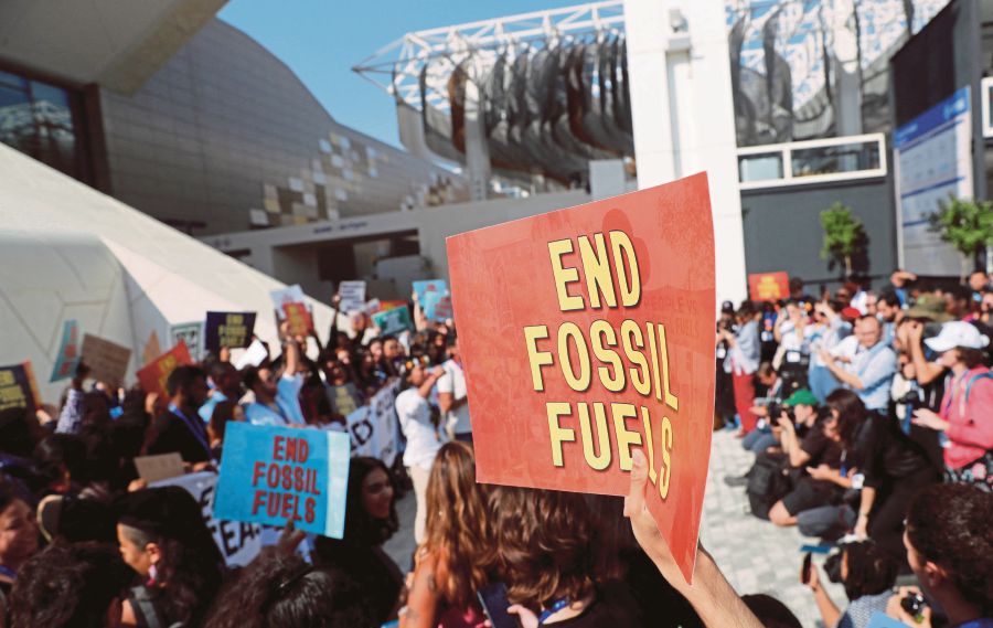 Climate activists protest against fossil fuels at Dubai's Expo City during the United Nations Climate Change Conference COP28 in Dubai, United Arab Emirates. (REUTERS/Thomas Mukoya)