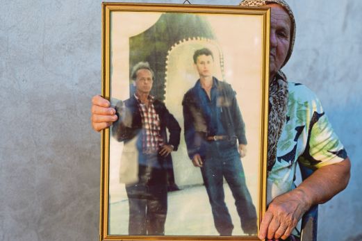 Remzija Delic holding the photo of her husband, Sabit (left). AP pic