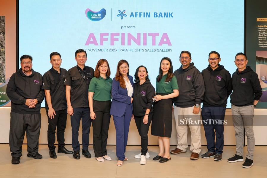 (From left) Affin Bank managing director of mortgage business Jessie Wong (fifth from left), UEM Sunrise Bhd chief executive officer Sufian Abdullah (third from right) and UEM Sunrise Bhd chief marketing officer Kenny Wong (far right) during the Affinita partnership announcement at the KAIA Heights sales gallery in Taman Equine on Thursday.