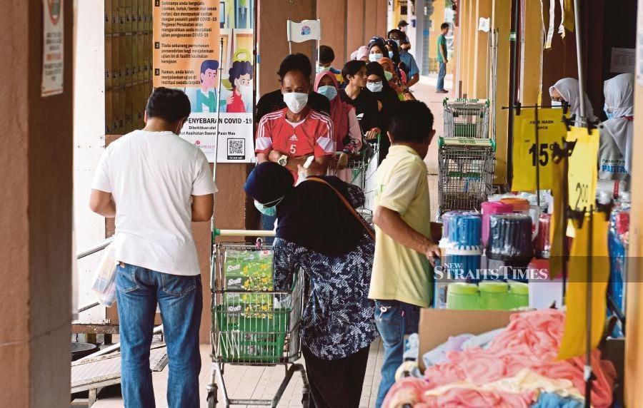 People buying essential items at a supermarket in Pasir Mas yesterday. PIC BY NIK ABDULLAH NIK OMAR