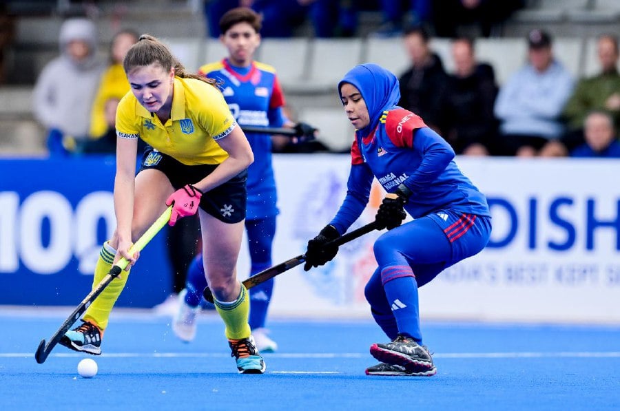 Malaysia (in blue) in action against Ukraine in the women’s Olympic Qualifier in Valencia, Spain, on Saturday. PIC FROM FIH